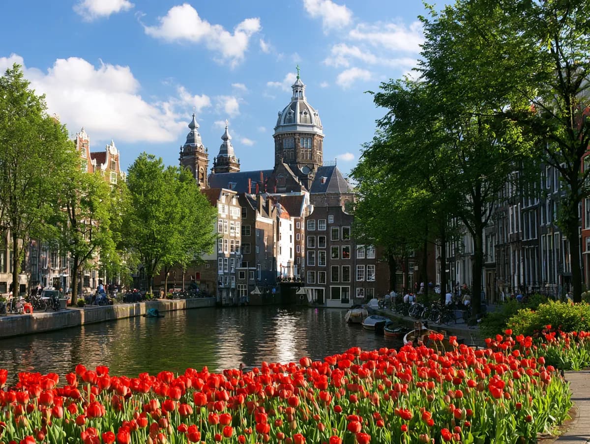 A canal lined with tulips and historic buildings in a European city
